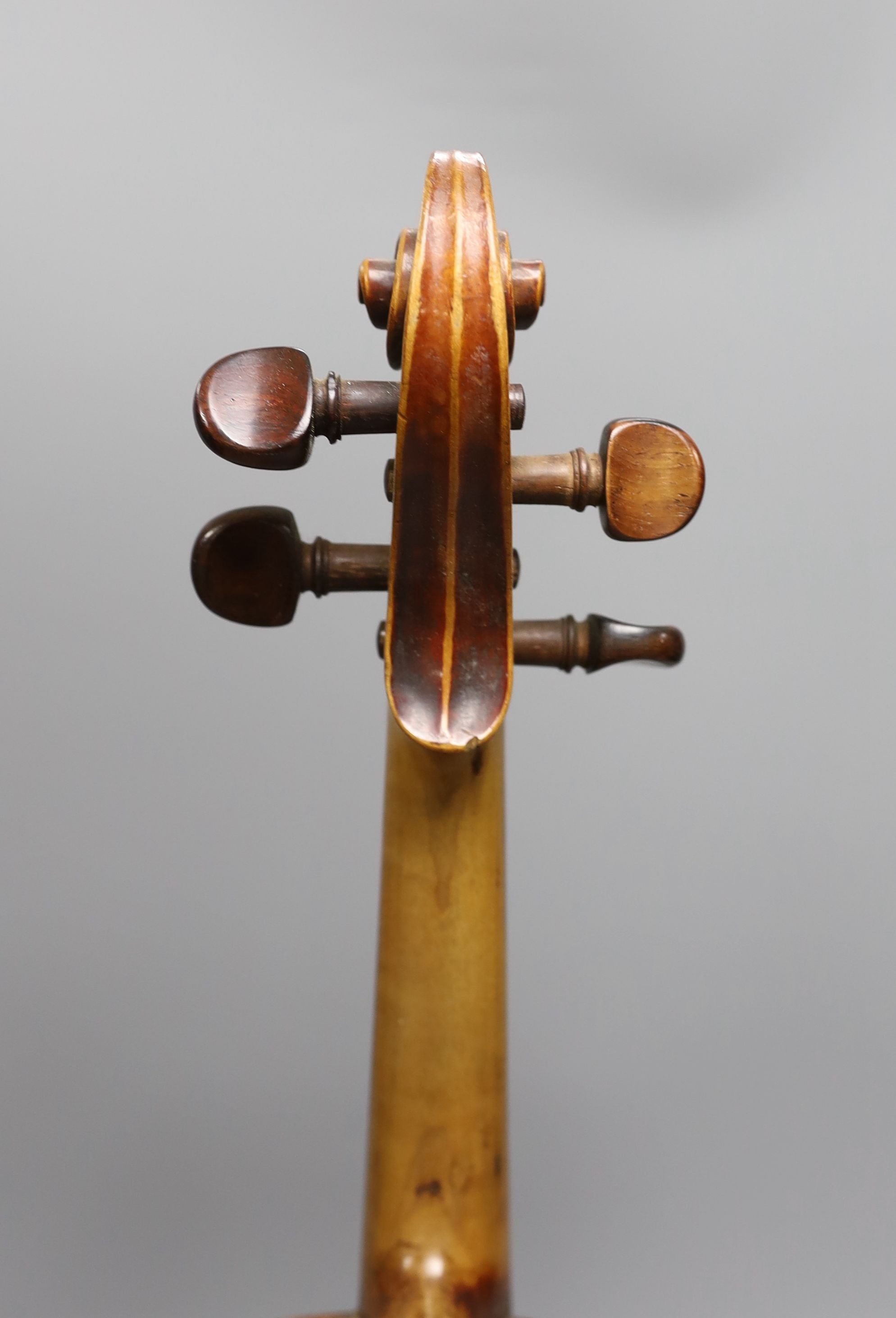 A 19th century violin with 14 inch 2 piece back, unlabelled, cased with silver mounted bow.